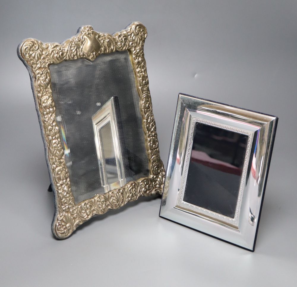 A modern repousse silver mounted easel mirror, 29.6cm and a base metal mounted photograph frame.